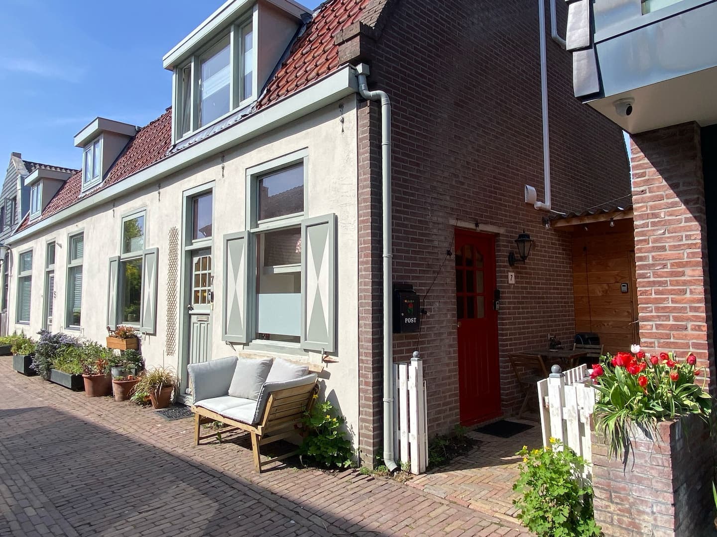 Street view of the cottage with its red side door